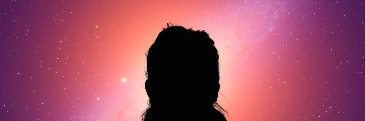 Silhouette of woman looking at starry sky