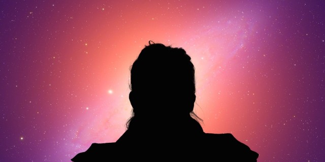 Silhouette of woman looking at starry sky