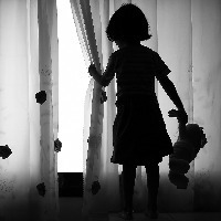 Lonely girl with doll.