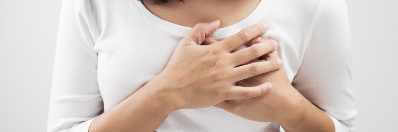 Choosing to Have Children Despite My Tricuspid Atresia Woman having a pain in the heart area