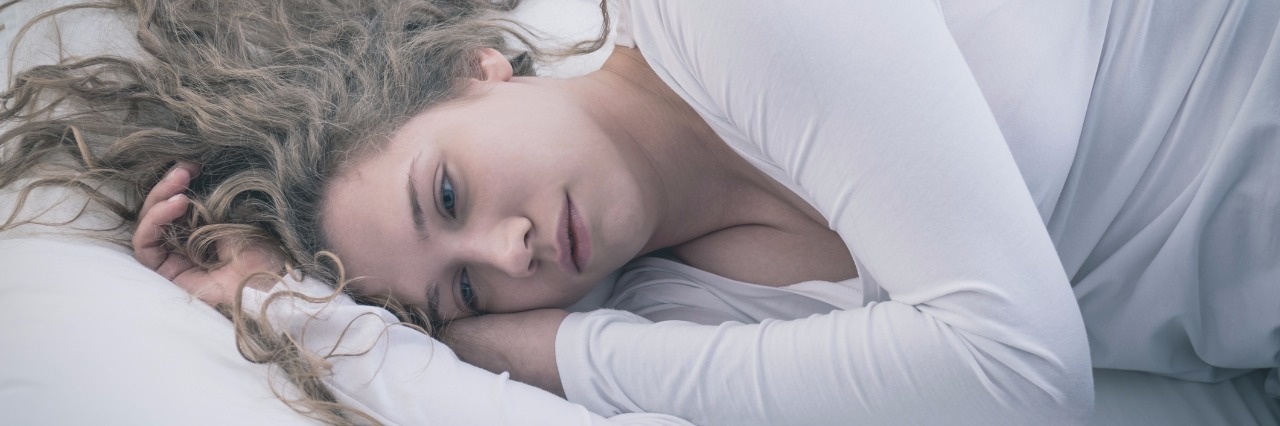 Depression: When You Can't Just Get Up and Get Moving depressed woman lying on a bed