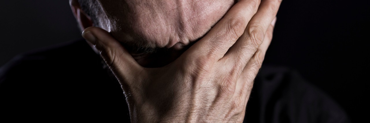 Reminders for When Someone You Love Attempts Suicide man burying his face in his hands