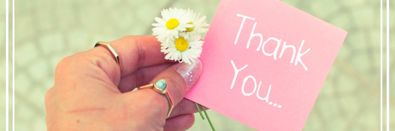 List of Things a Woman With a Mental Illness Is Grateful For hand holding a paper that says Thank You