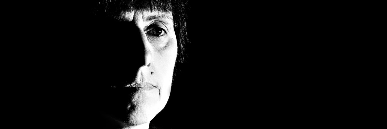 What to Remember When Depression Makes You Feel Numb Older woman in harsh lighting, semi profile.