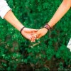 young couple holding hands in a park
