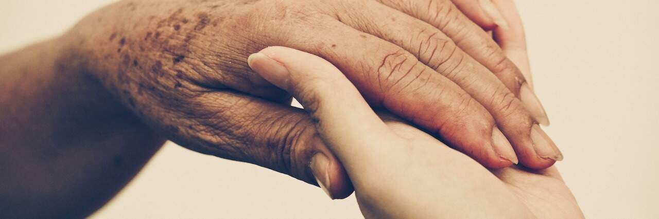 We Shouldn't Underplay Compassion's Role in Suicide Prevention Two hands gripping each other