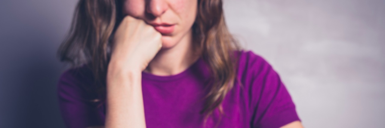 Fighting Boredom When You're 'Stable' in Bipolar Disorder a bored woman looking at her smartphone