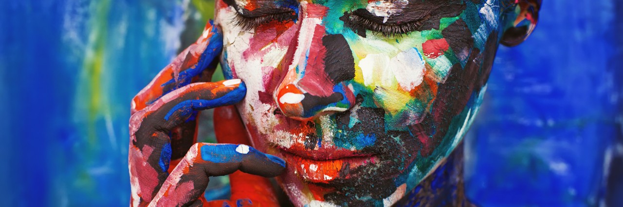Lyme Disease: Dealing With Rejection From Friends and Family Living painting - young woman completely covered with thick paint