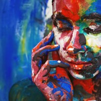 Living painting - young woman completely covered with thick paint