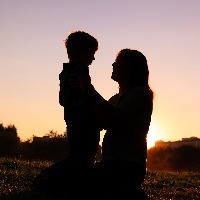 happy loving mother and little son at sunset