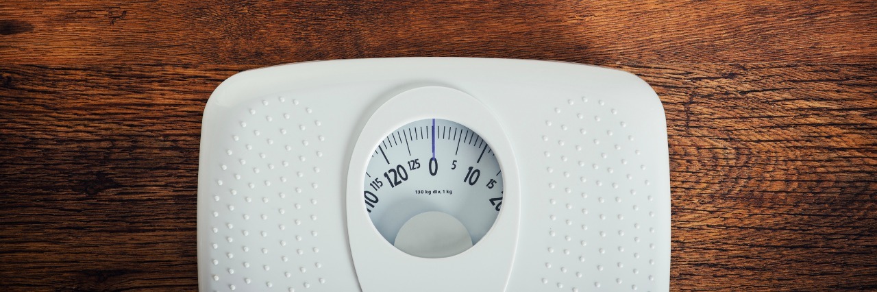 Eating Disorder Recovery in College: Gaining the 'Freshman 15' weight scale on hardwood floor