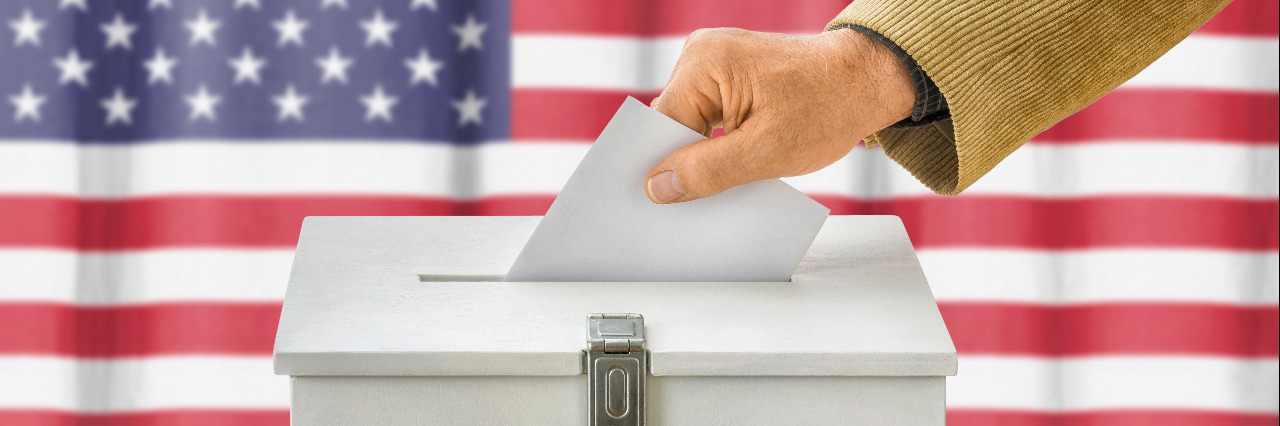 Will the Next President Care About Me, a Blind, Transgender Man? Man putting a ballot into a voting box.