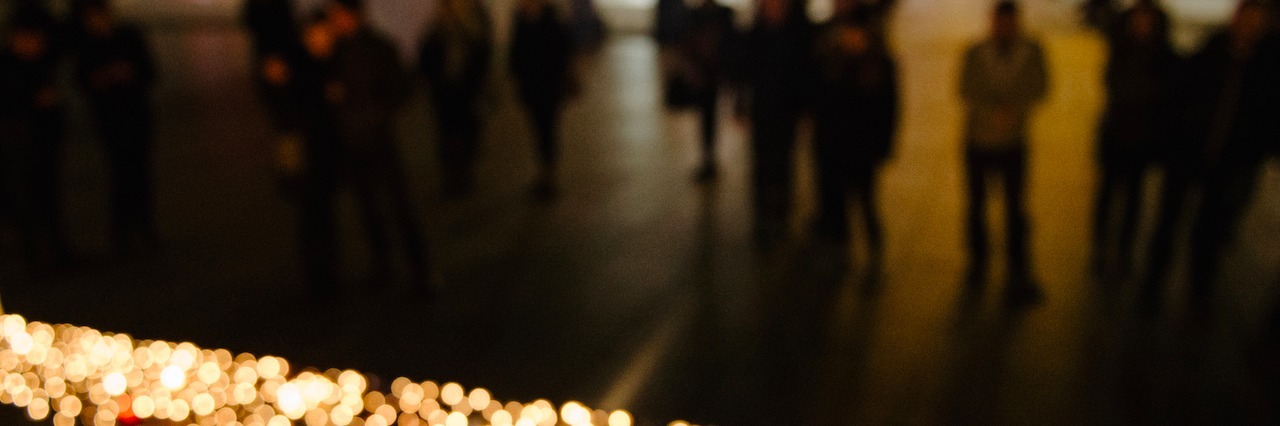 We Shouldn't Blame Those Who Die by Suicide on Their Death a group gathered in the dark