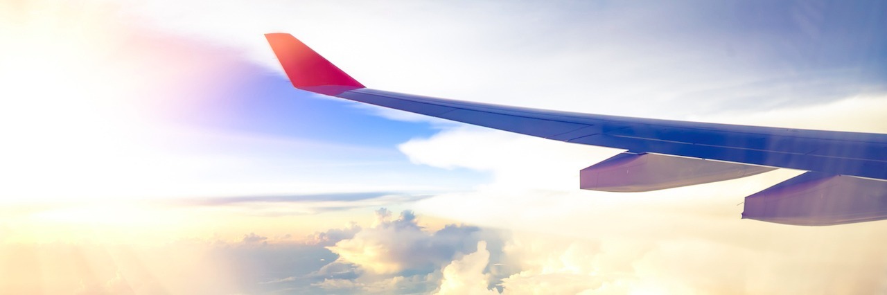 When My Flight Was Delayed Because of a Passenger's Panic Attack view of the sky from an airplane