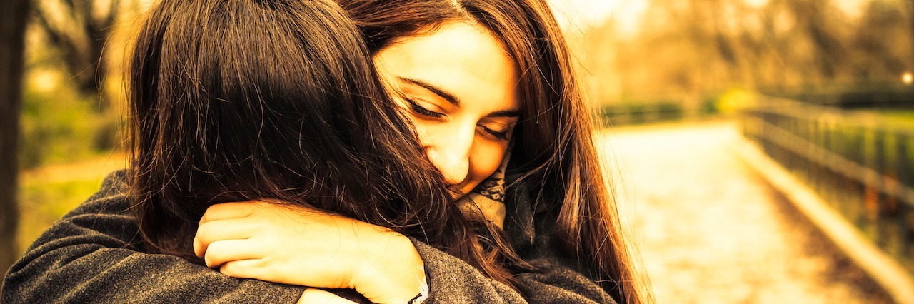 A Letter to My Friend Who Has Stuck With Me Through Depression two friends hugging in the park