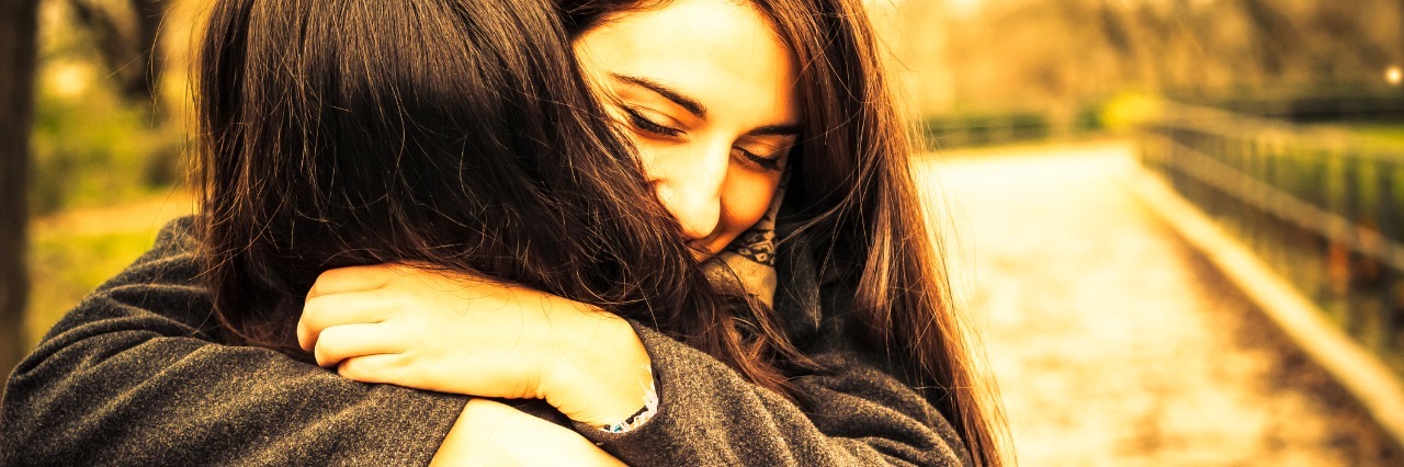 Letter to a Friend During Hard Moments girl hugging her best friend in the park