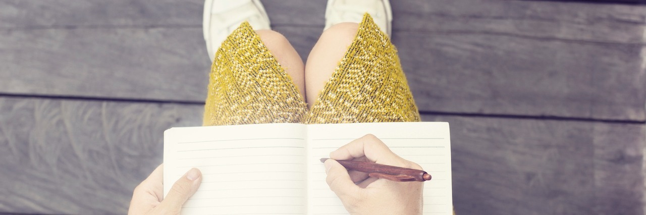 girl writing in a diary