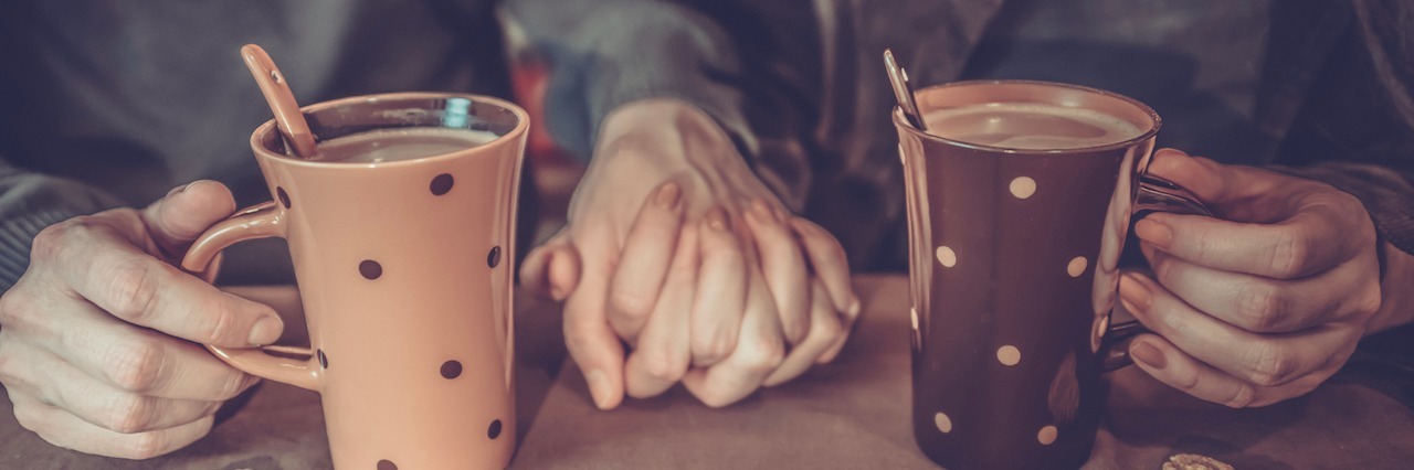 How to Show You Care About a Loved One With Anxiety couple holding hands and drinking coffee