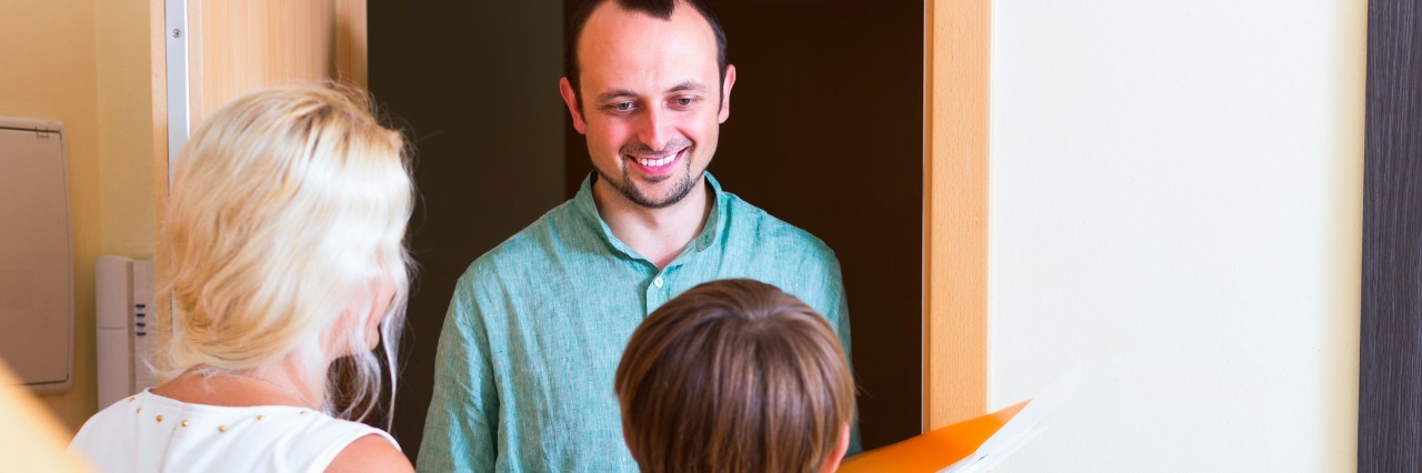 How to Explain Snyder-Robinson Syndrome to Strangers Family greeting guest at the door