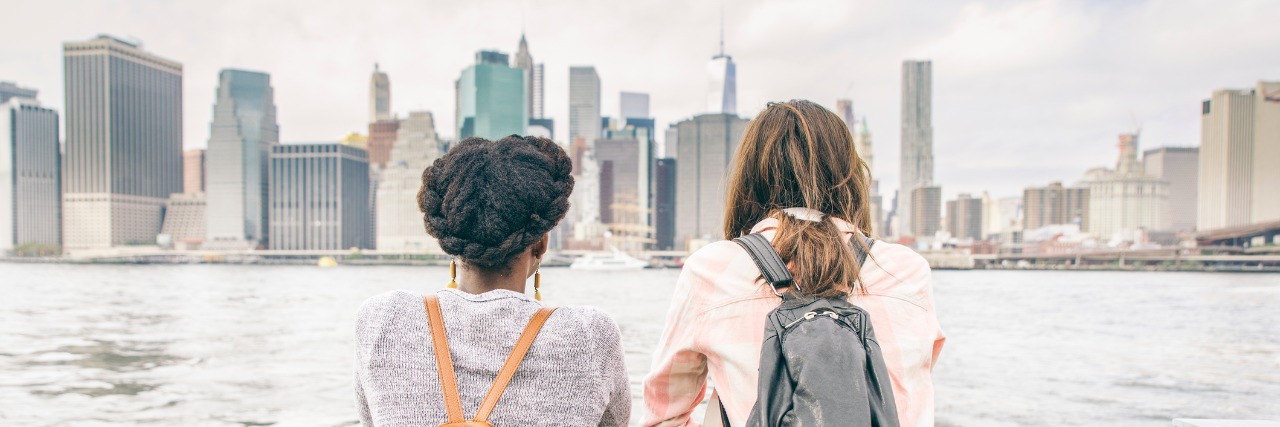 two girls looking at new york city skyline