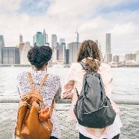 two girls looking at new york city skyline