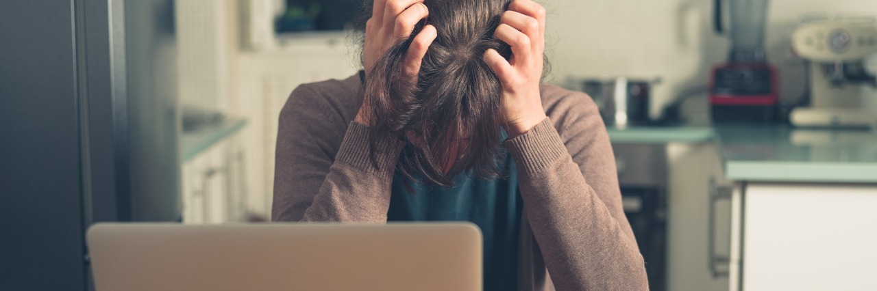 Mental Health Advocates' Outrage Must Turn Into Action woman frustrated, looking at her laptop