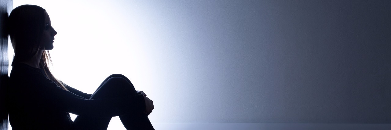 What I Wish I Knew After a Major Depressive Disorder Diagnosis Teenager with depression sitting alone in dark room