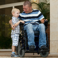 Dad who uses a wheelchair plays with child.