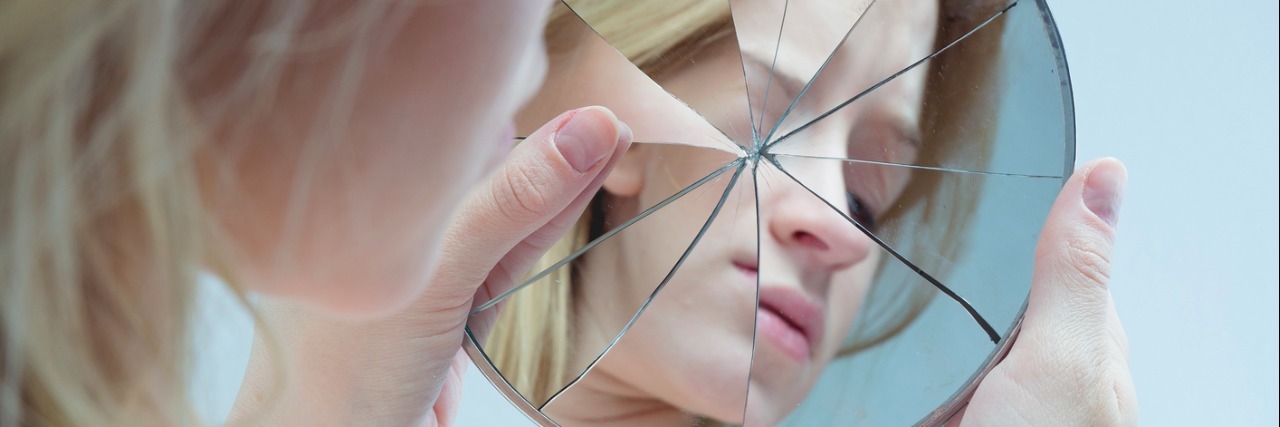 Letter to Myself When I Want to Return to My Eating Disorder a young woman looking at herself in a cracked mirror