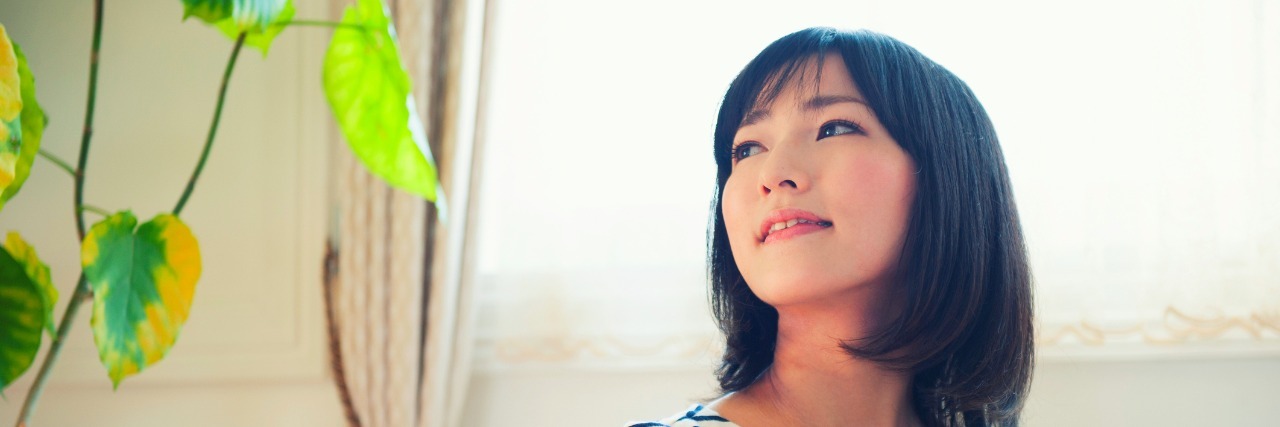 Clinging to My Mental Illness Young woman who sits down on a chair