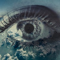 Woman eye on the background of clouds.