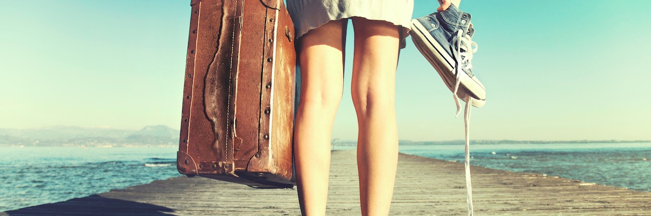 Eating Disorder: Why I Believe in Full Recovery woman standing on a dock holding her shoes and a suitcase