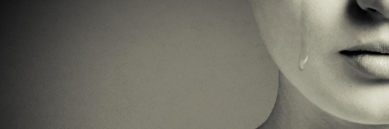 Sharing Your Feelings Doesn't Make You Weak a woman with a tear running down her face