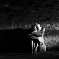 Lonely young woman sitting on the street