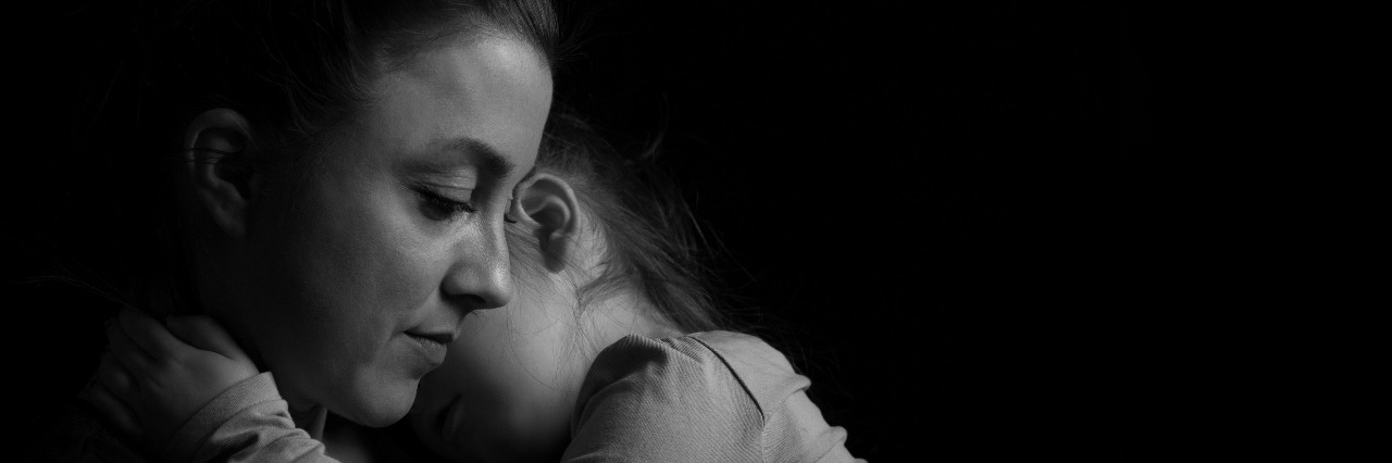 When I Questioned Where God Was After My Child's Rare Diagnosis Black and white Picture of a child hugging her mother.Silhuette picture.