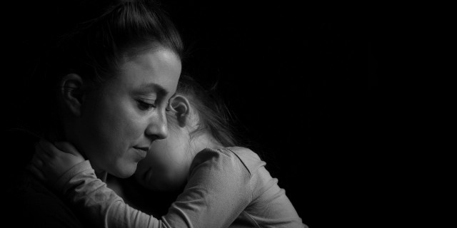 When I Questioned Where God Was After My Child's Rare Diagnosis Black and white Picture of a child hugging her mother.Silhuette picture.