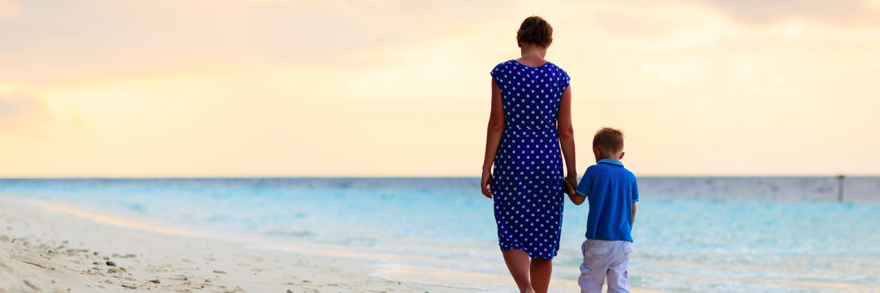 A Letter to My Son With Autism: What I Don't Want to Forget Mother and son walking on a beach at sunset