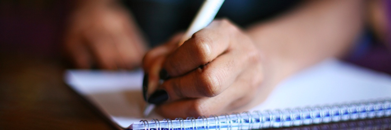 A Letter to My Friends and Family Struggling With Mental Illness woman writing in a notebook