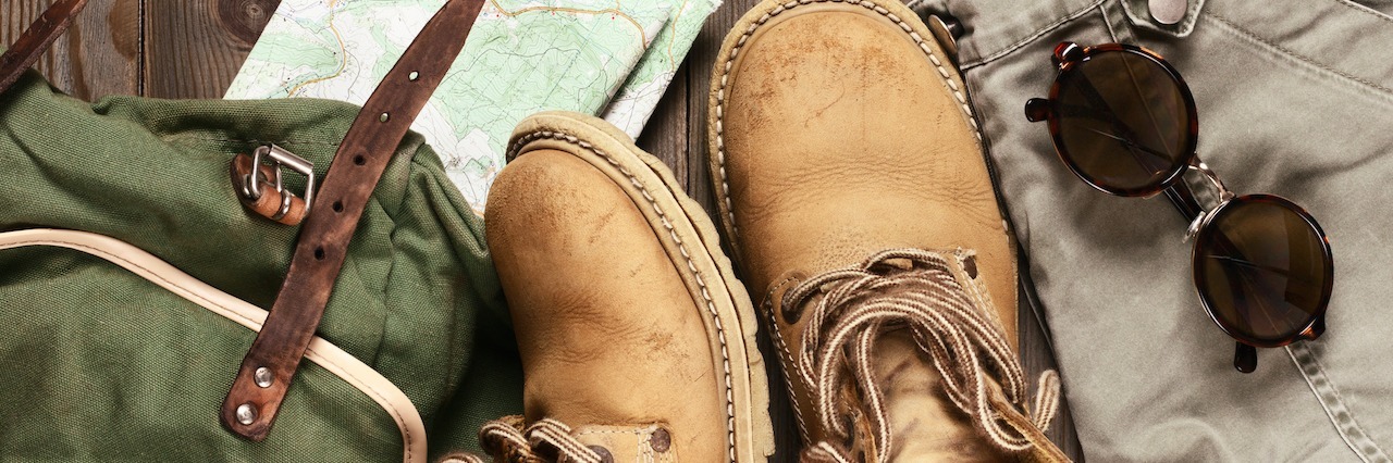 Transitioning to Life After Depression and Anxiety Treatment hiking boots, a backpack and a map placed on a wooden floor