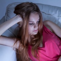 young woman looking tired on the couch