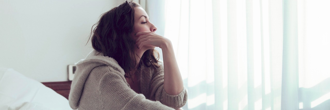 Depressed and Unable to Get Out of Bed woman sitting in bed