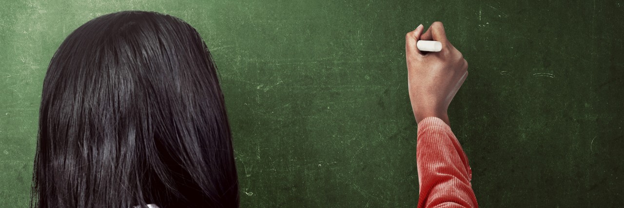 Tips for Surviving College With an Anxiety Disorder woman drawing something on the blackboard