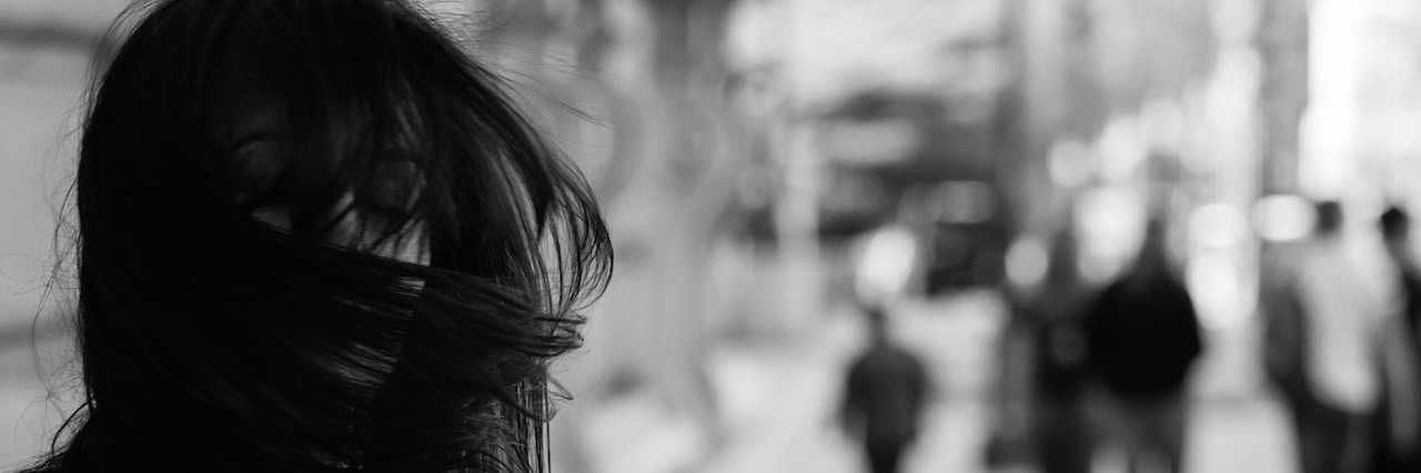 When You Feel Like a Failure After Relapsing Into Self-Harm woman with her dark hair covering her face