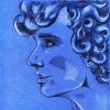 Portrait of young curly haired man on blue paper background