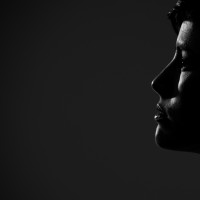 Silhouette side portrait of young pretty woman looking away