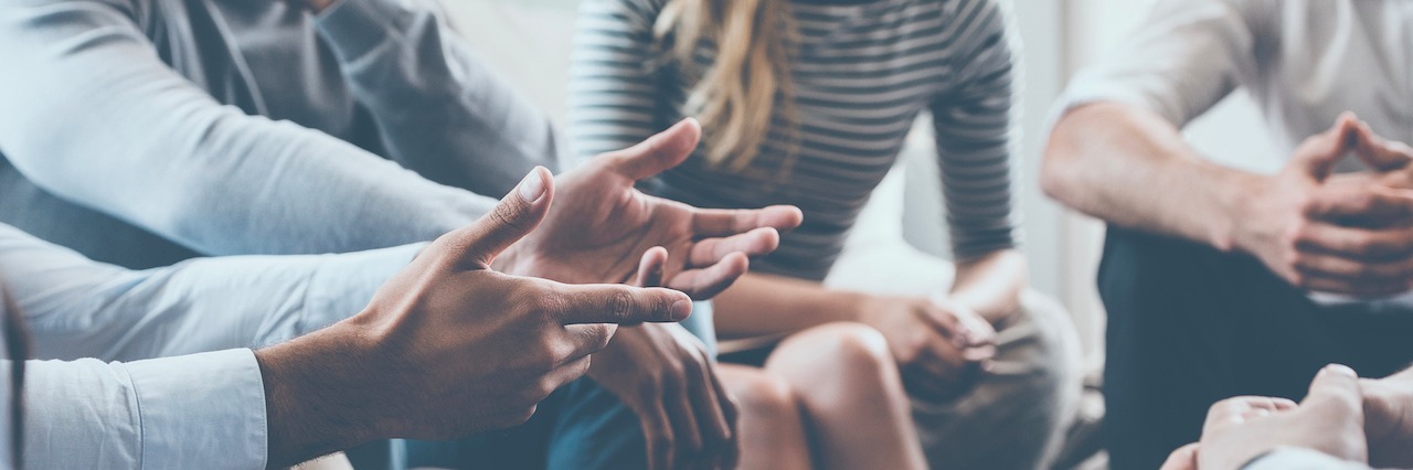 How Group Therapy Has Helped Me in Life With BPD a group of people sitting in a circle, talking