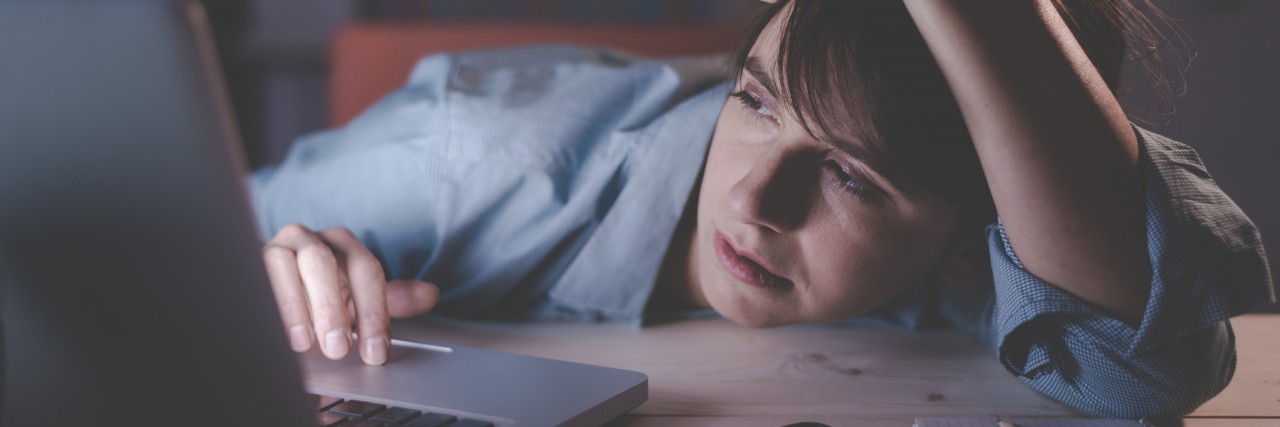 Dealing With Having No Energy Because of Chronic Illness Sleepy woman working with her laptop