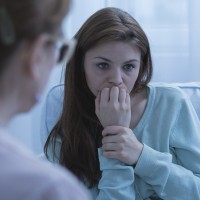 Cropped shot of a worried woman thinking in a doctor's office