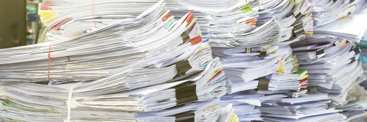 Autism Spectrum Disorder and the Dreaded Waiting Lists Pile of documents on desk stack