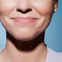 A woman smiling with her mouth closed